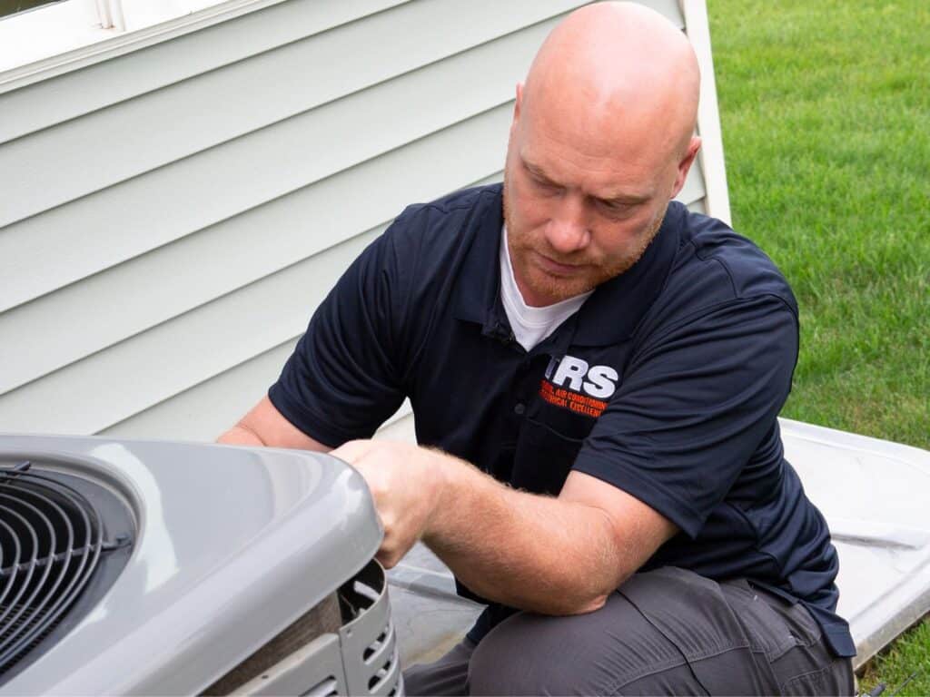 Technician servicing an air conditioner